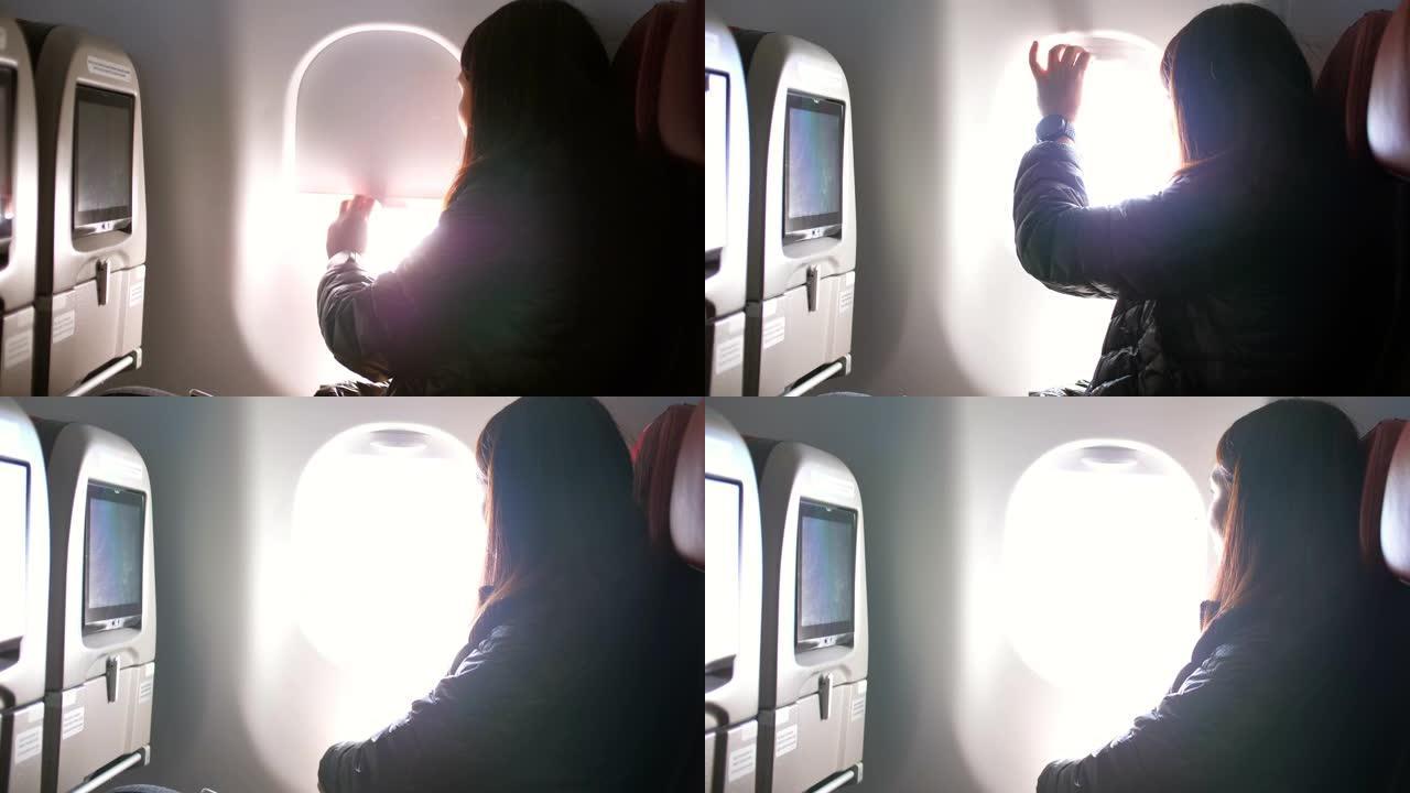 女乘客打开飞机机舱的窗户，慢动作