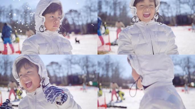 快乐的小男孩扔雪。