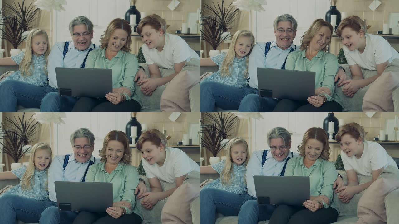 孩子们正在和他们的奶奶和爷爷一起浏览笔记本电脑