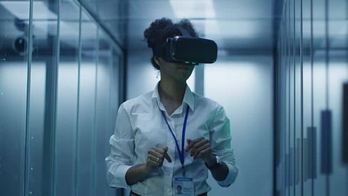 在数据中心工作的VR眼镜中的民族妇女