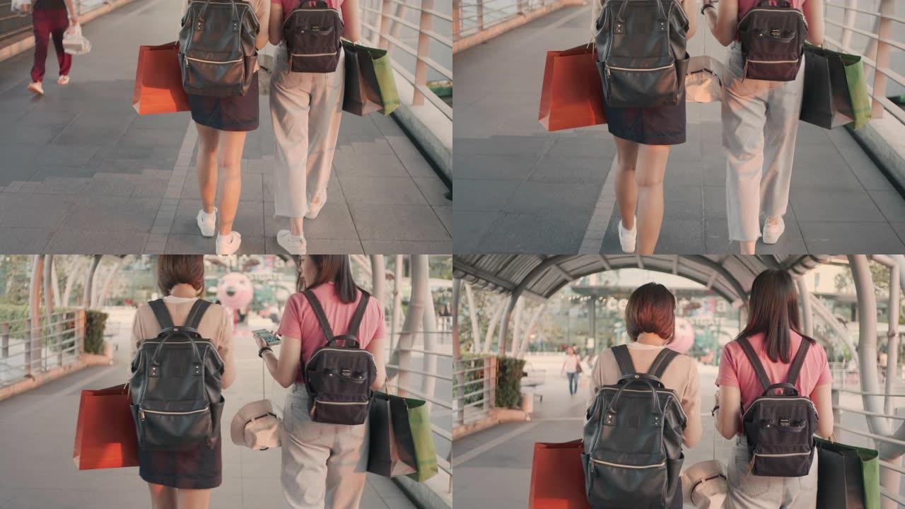 两名女性游客走路和使用智能手机，慢动作