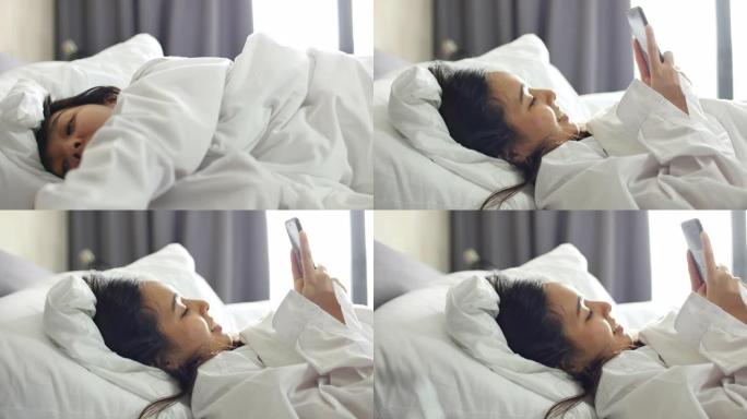女人在家中躺在床上使用手机。青少年使用社交媒体