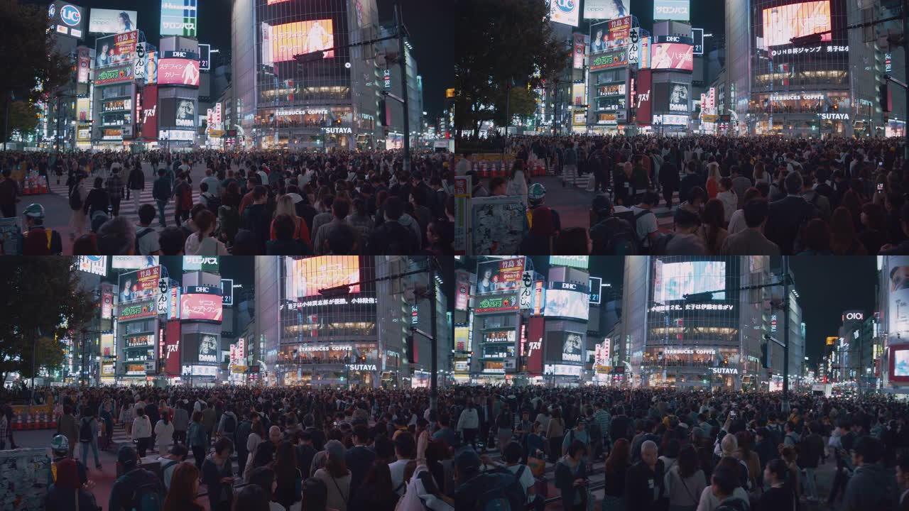 4k分辨率在涩谷十字路口拥挤了人们的夜生活。交通汽车和跨交叉路口的交通工具