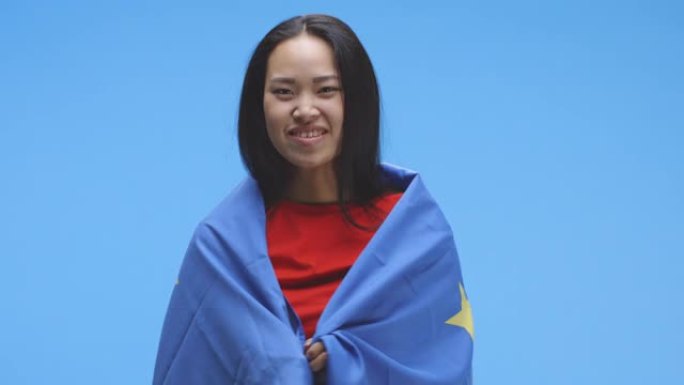 年轻女子裹着欧盟国旗跳舞