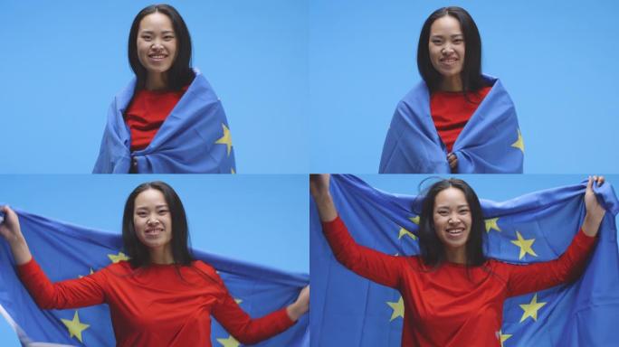 年轻女子裹着欧盟国旗跳舞