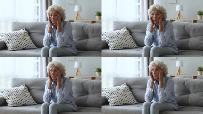 强调担心的老年妇女担心家里的健康问题
