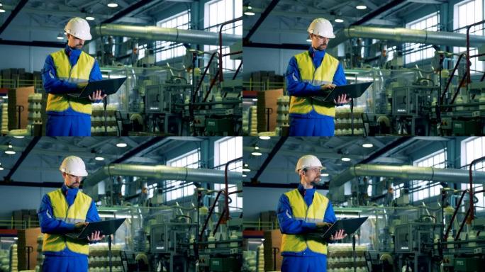 工厂单位生产化学药品，一名男性工人操作笔记本电脑
