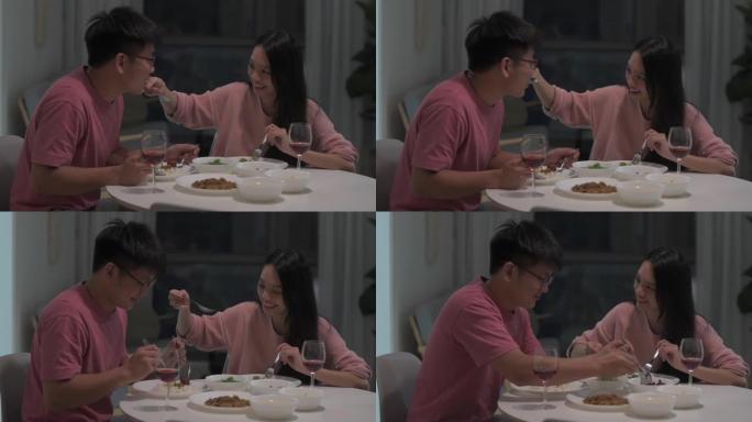 2亚洲华裔夫妇在家用餐，品尝东方美食和红酒
