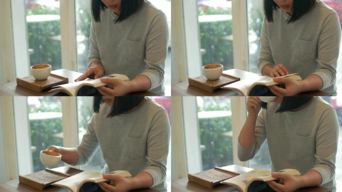 女人看书，在咖啡馆喝咖啡