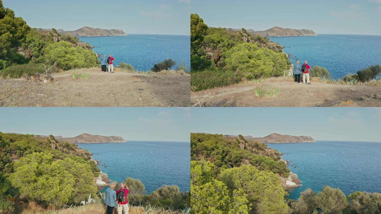 高级夫妇徒步旅行时欣赏地中海海岸的景色