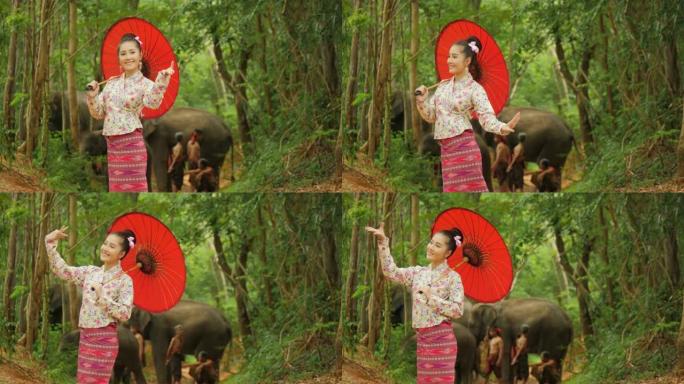 在自然背景中跳舞的传统东南亚服装中迷人的亚洲女人的肖像。