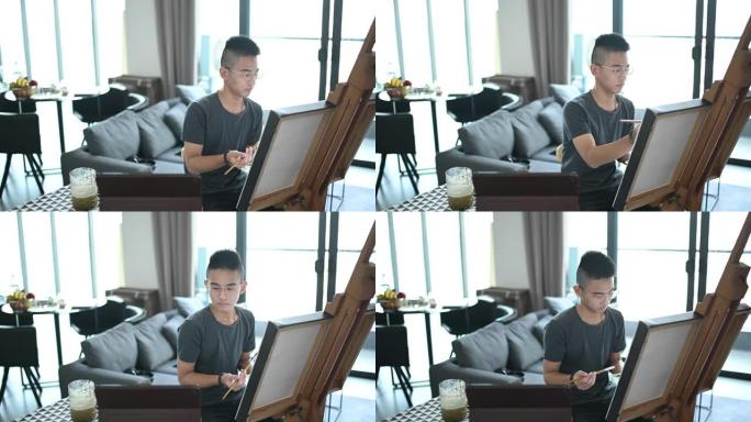 一名亚洲华裔少年在客厅家中画丙烯画