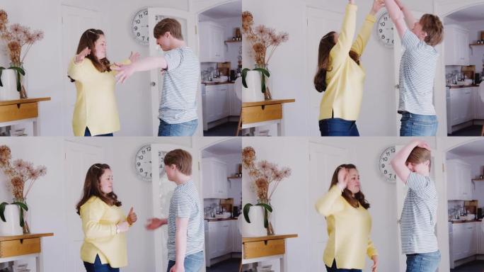 年轻的唐斯综合症夫妇在一起在家里跳舞很开心