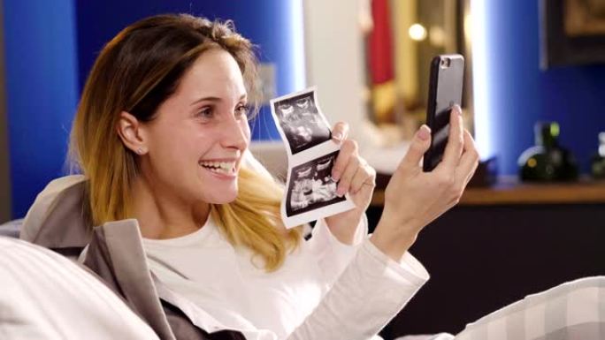 一个女人，用丈夫的平板电脑进行视频聊天，宣布孩子的出生，然后怀孕，向他展示超声波。