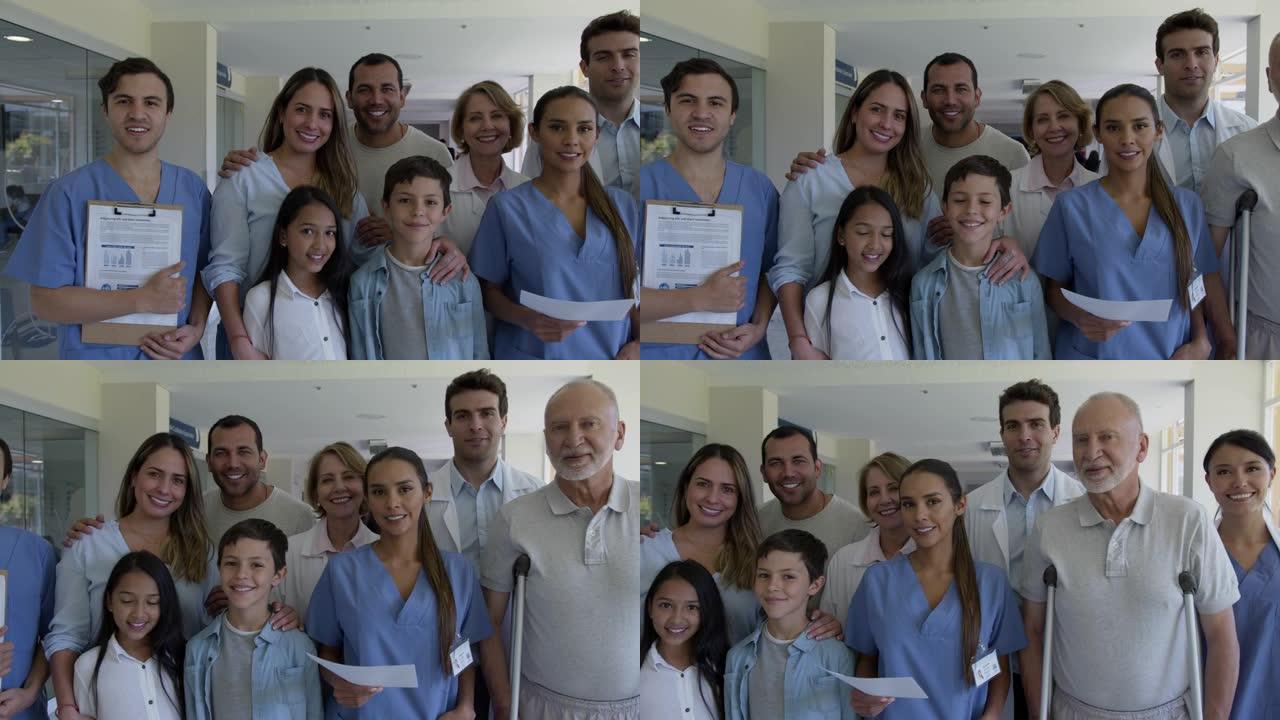 快乐的一群拉丁美洲医护人员与病人在医院面对镜头微笑