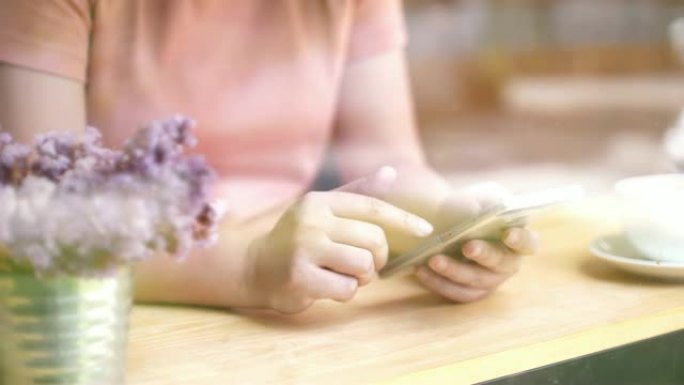女人在咖啡厅使用智能手机，慢动作