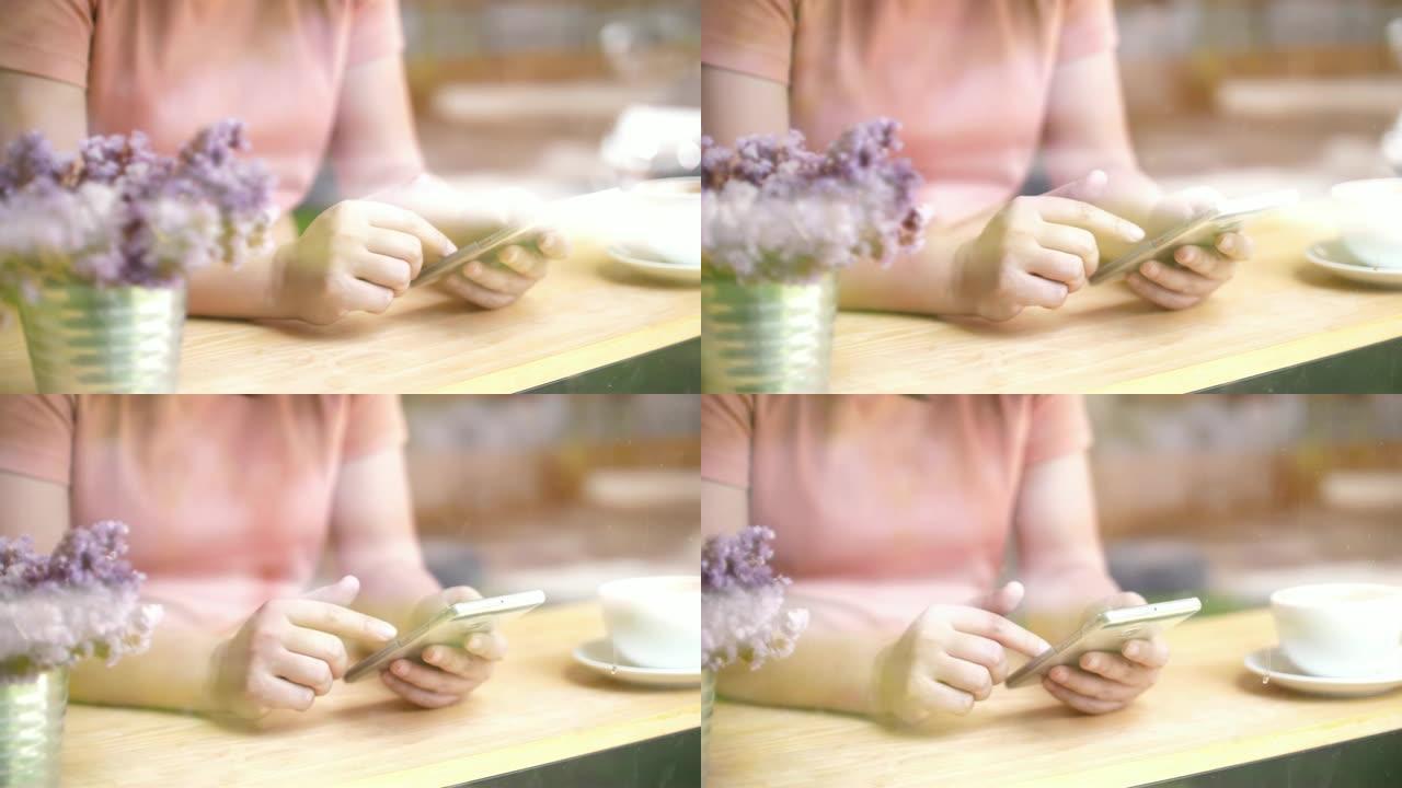 女人在咖啡厅使用智能手机，慢动作