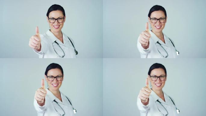 一位穿着白色外套和听诊器的女医生的肖像在白色背景上微笑着看着相机。