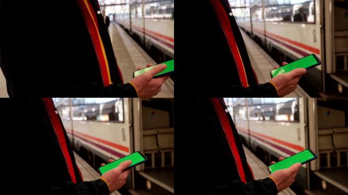 使用带有绿屏的智能手机的人的特写