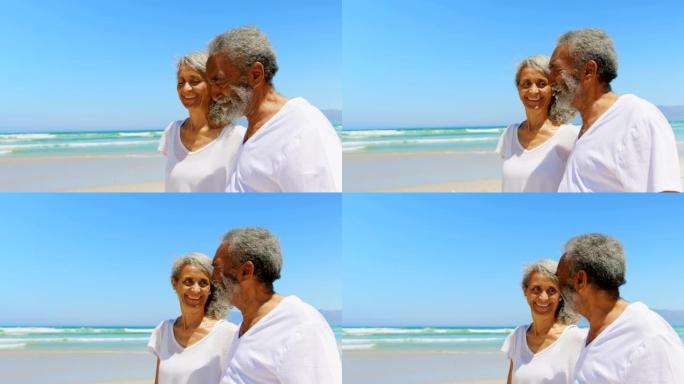 快乐活跃的老年非洲裔美国夫妇在阳光下4k在海滩上散步的侧视图