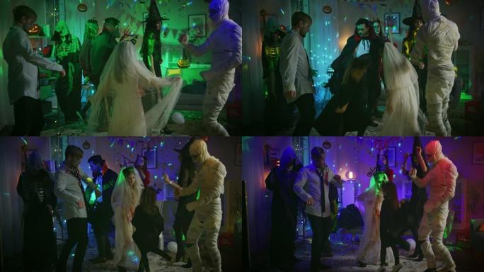 万圣节服装派对: 一群怪物在装饰有迪斯科球灯的房间里跳舞。僵尸，吸血鬼，木乃伊，美丽的女巫，她的魔鬼