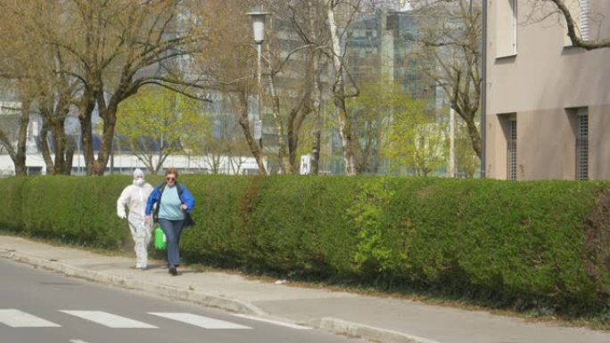 病毒专家在试图给她消毒的同时在街上追赶老年妇女。