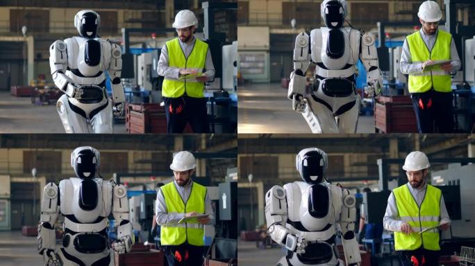 工厂工人使用平板电脑检查行走的机器人。