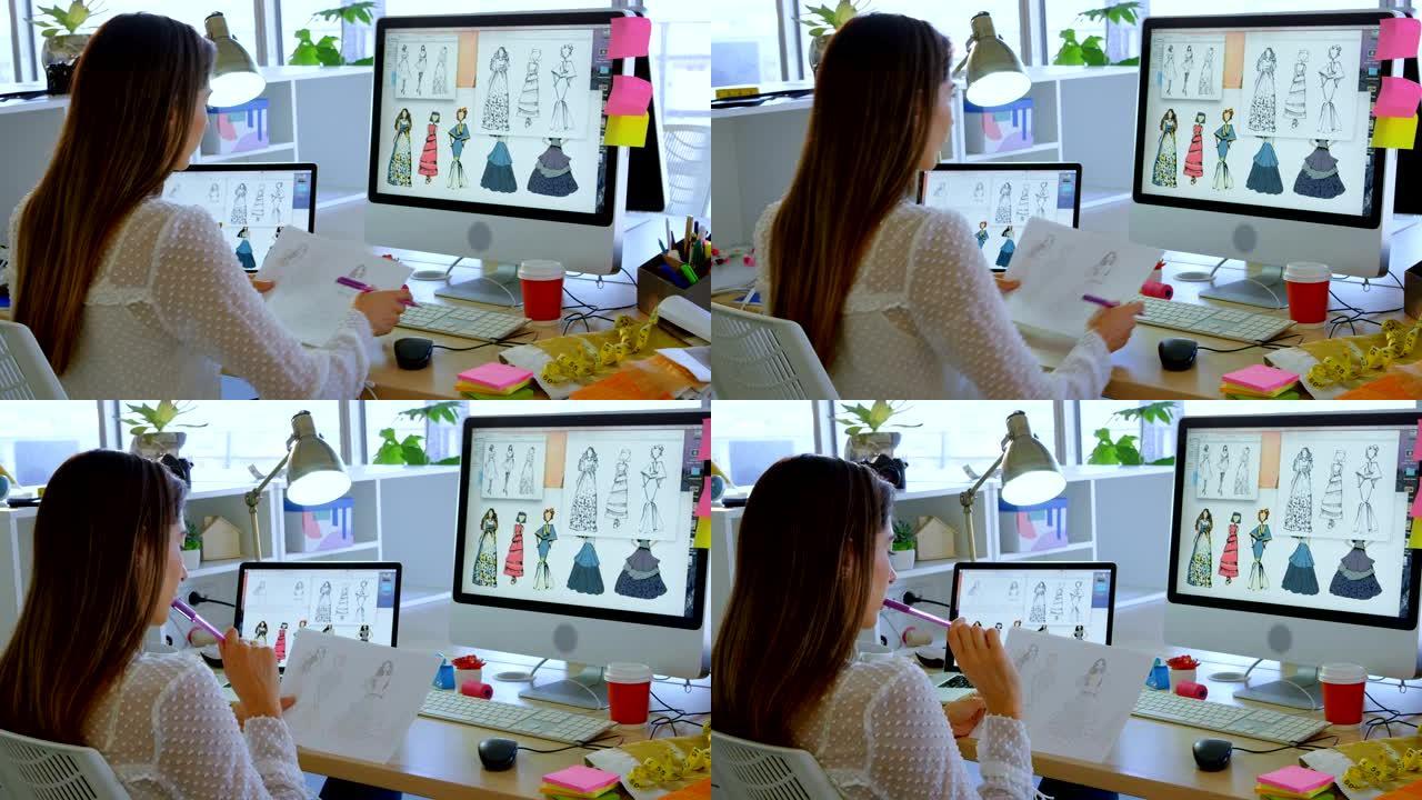 白人女性时装设计师在办公室4k办公桌上电脑工作的后视图
