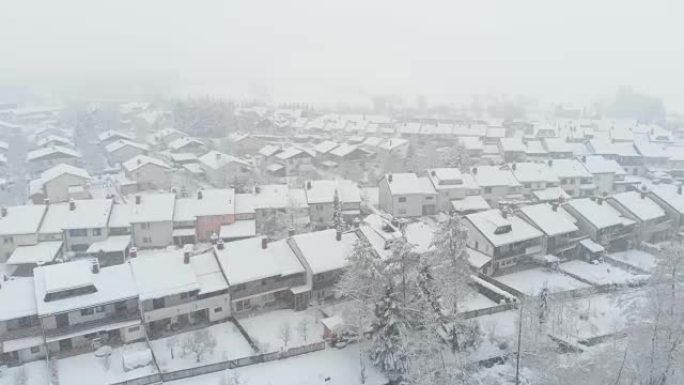 空中: 下雪天在郊区的空荡荡的街道上飞行。