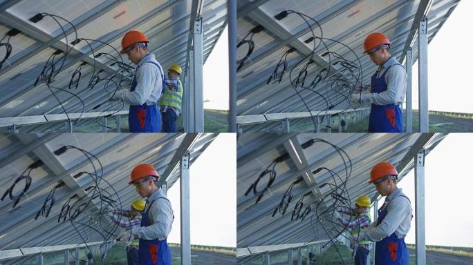 工人连接太阳能电池板的电线