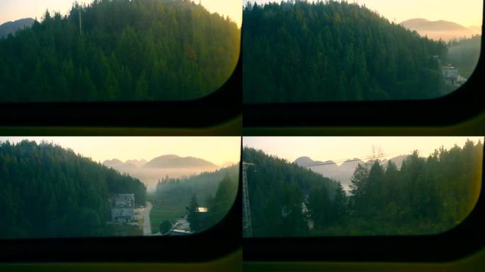 火车窗口视图车窗外山区绿色植物