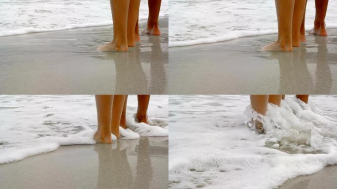 低矮的情侣赤脚站在海滩4k