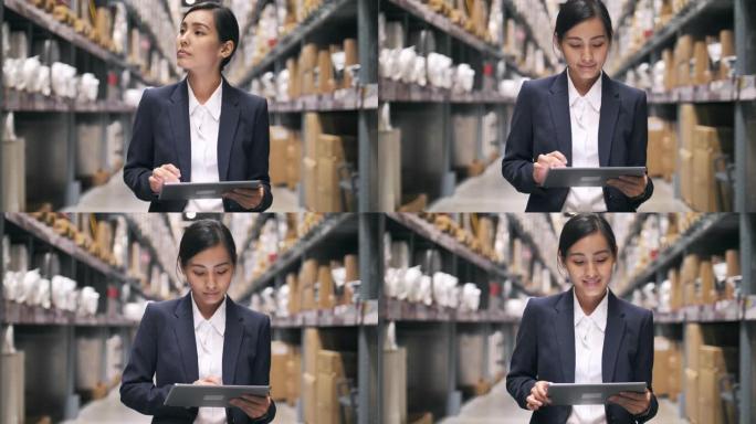 亚洲女商人使用数字平板电脑检查仓库中的运输清单