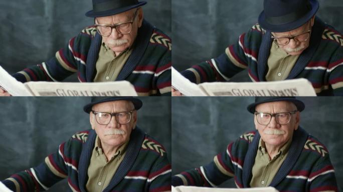 戴着帽子的老人阅读报纸
