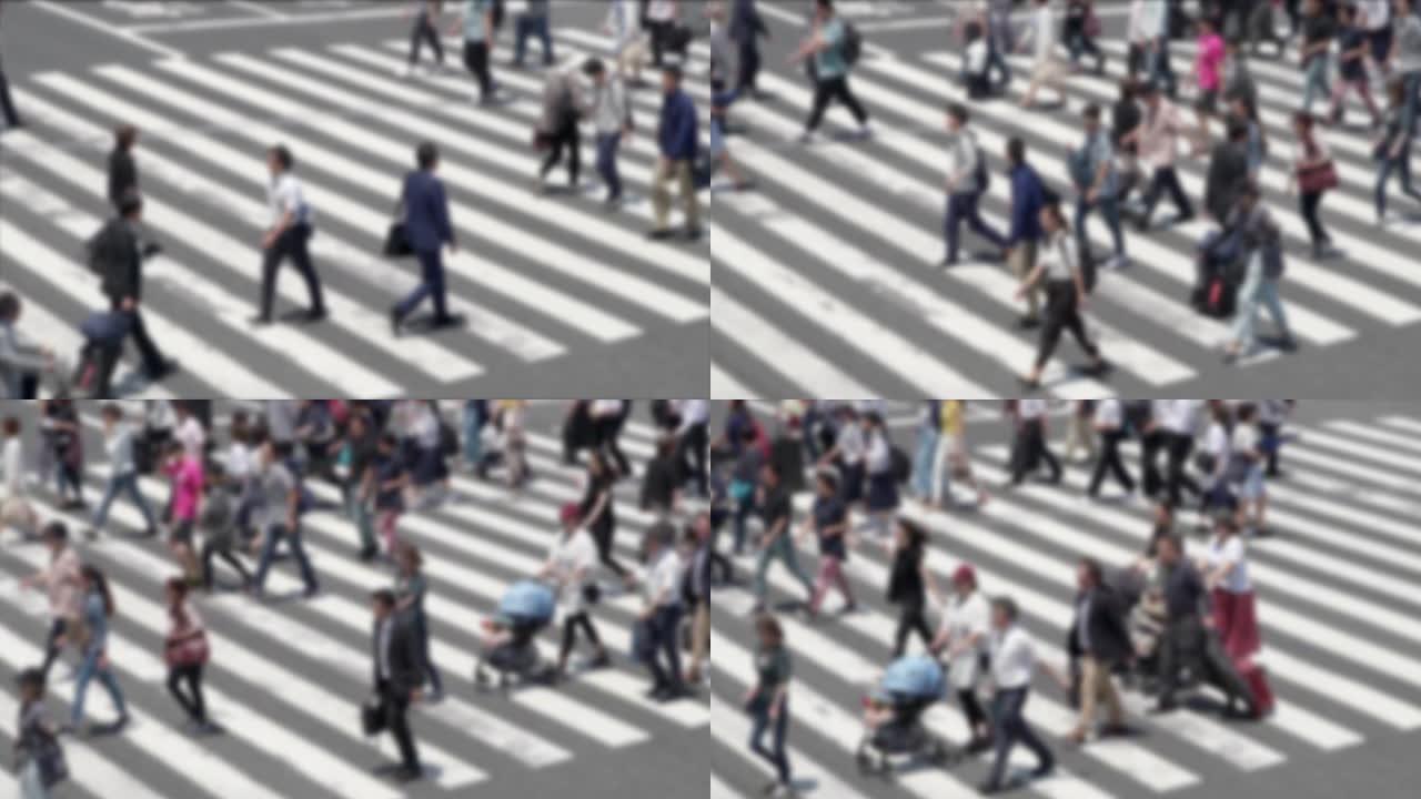 散焦的慢动作日本人在日本东京的斑马线上行走