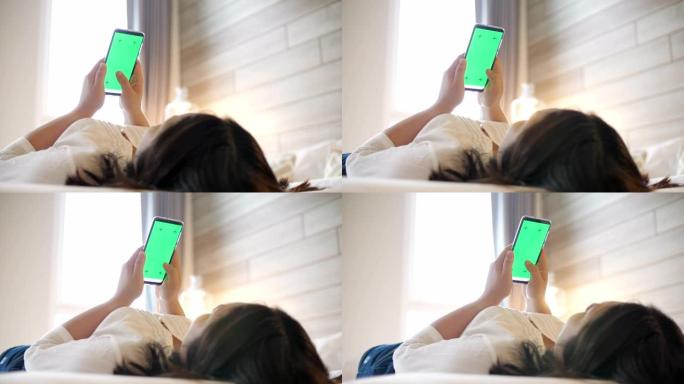 女人手触摸手机，卧室床上绿屏，慢动作