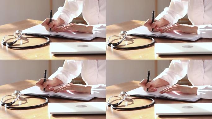 女医生穿白色制服在笔记本上做笔记，特写