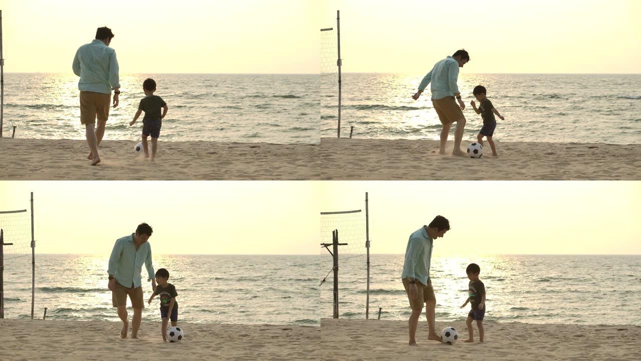 亚洲父子在日落背景下的海滩上踢球。慢动作。幸福家庭理念。