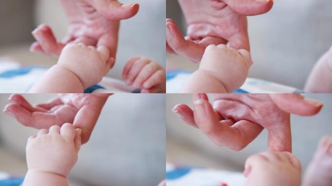 小儿子用慢动作抓住母亲的手指拍摄的特写镜头