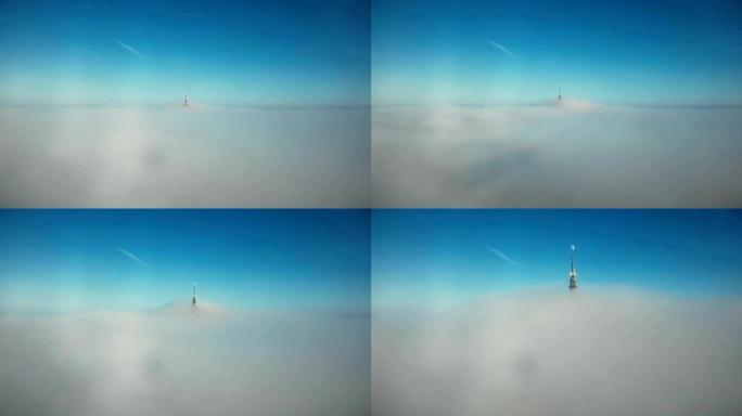 无人机在湛蓝的天空中飞向白云上方，朝着空灵的天堂圣米歇尔·金城堡尖顶。