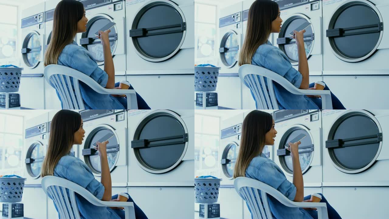 女子在自助洗衣店4k手机上聊天