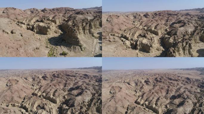 一辆野生动物园车辆的4k空中倾斜视图，让游客看到纳米比亚纳米布沙漠的古老地质岩层