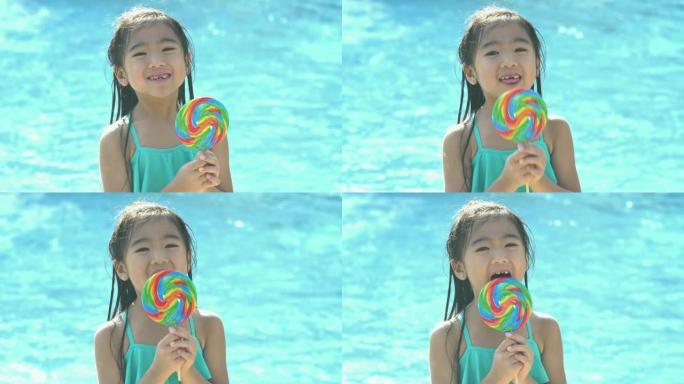 亚洲女孩在游泳池边舔巨大的棒棒糖
