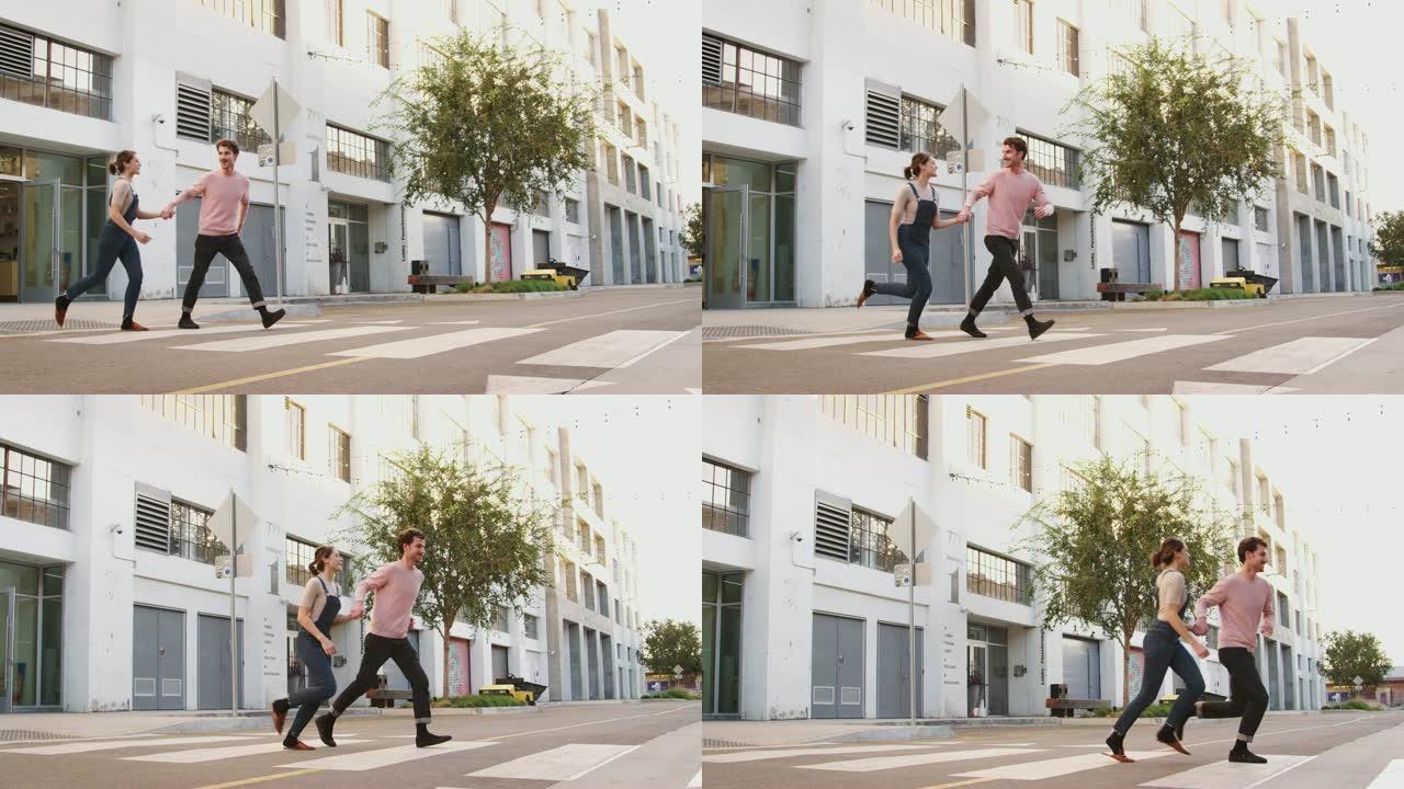 千禧一代潮人夫妇牵着手在城市的马路上奔跑，全长