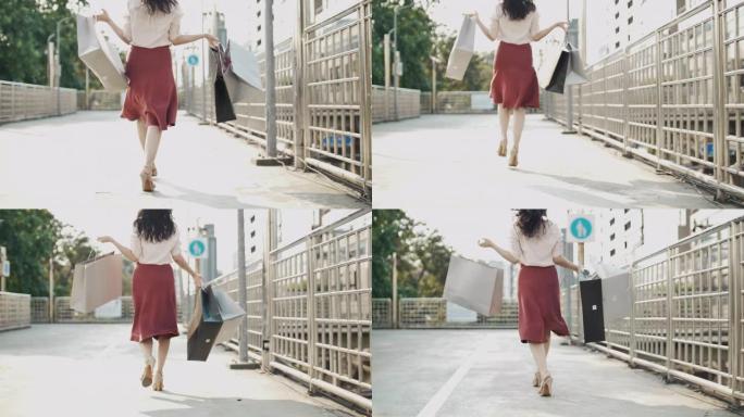 购物狂女人快乐购物用购物袋跳跃