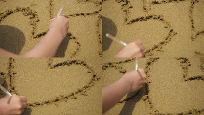 女孩在沙滩上画心脏符号。