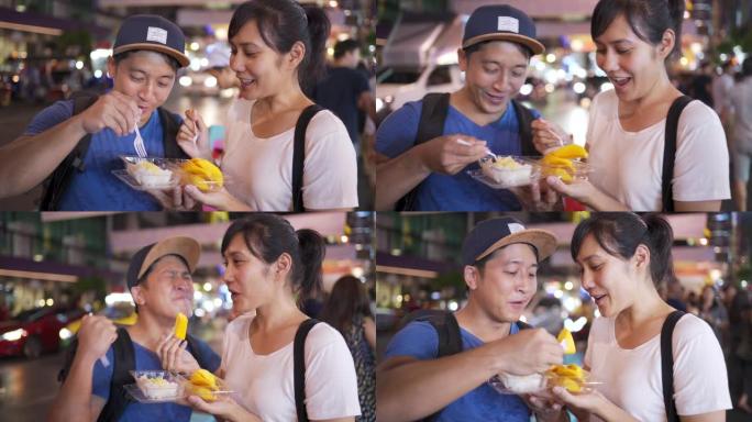 街头美食 -- 泰国曼谷姚瓦拉特路吃芒果糯米饭的年轻夫妇