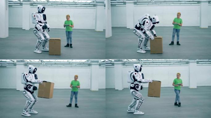 十几岁的男孩命令机器人抬起箱子