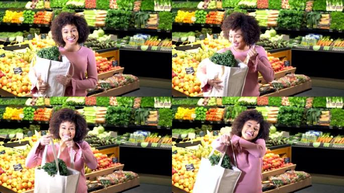 年轻的非洲裔美国人在超市里用可重复使用的袋子