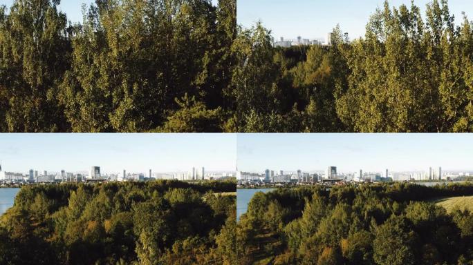 无人机升起在绿树之上，展现明斯克白俄罗斯平静的秋湖和现代未来派城市天际线风景。